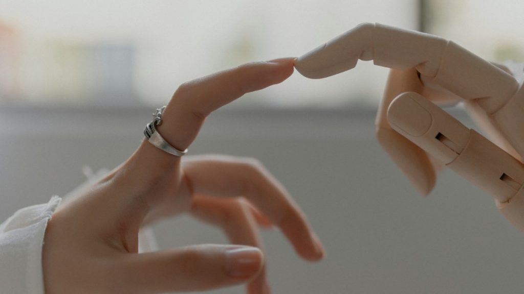 A human hand reaching toward a robotic hand