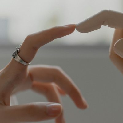 A human hand reaching toward a robotic hand