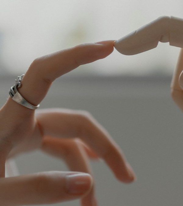 A human hand reaching toward a robotic hand
